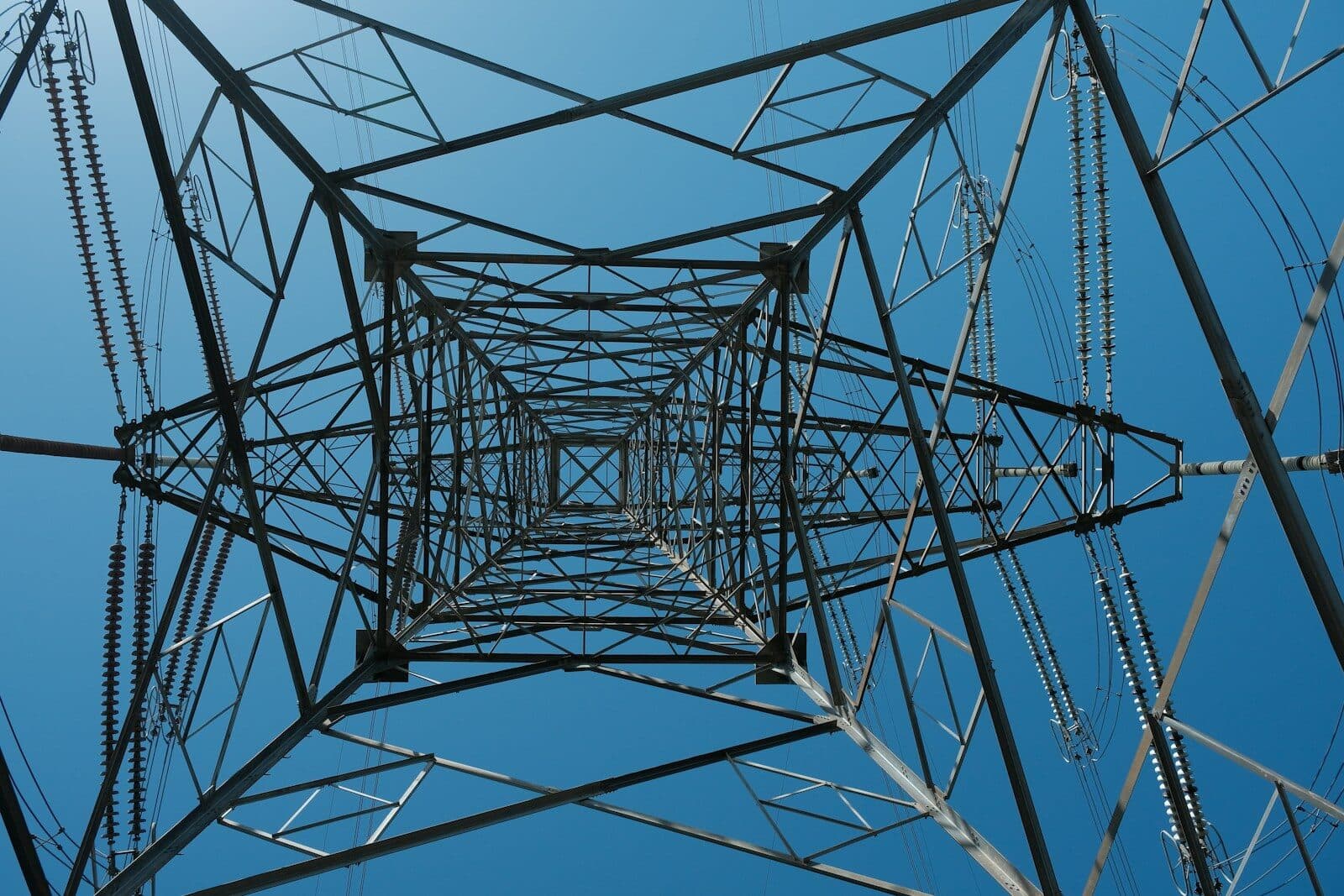 Looking up through a steel power line tower